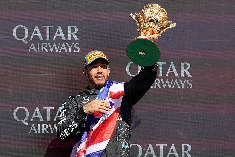 Lewis Hamilton celebrates after winning British Formula One - | Photo: AP/Luca Bruno